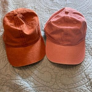 Women’s orange and pink hats